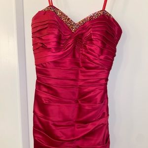 Red rouched semi formal dress with embezzled stones across chest
